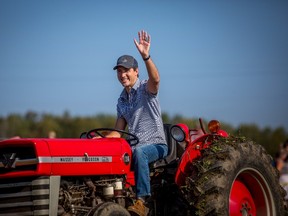 Justin Trudeau drives a tractor at the International Plowing Match and Rural Expo in Walton, Ont. (CP photo)