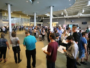 Long lines of job-seekers wind around the lobby of the Western Fair District Agriplex waiting to enter Tuesday?s London and Area Works Job Fair. The event, sponsored by London Economic Development Corp., featured more than 50 employers and drew thousands of would-be workers. (Mike Hensen/The London Free Press)
