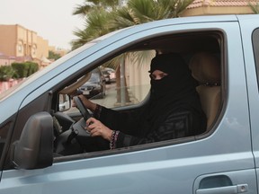 In this Saturday, March 29, 2014 file photo, a woman drives a car in Riyadh, Saudi Arabia, as part of a campaign to defy Saudi Arabia's ban on women driving. (AP Photo/Hasan Jamali, FILE)