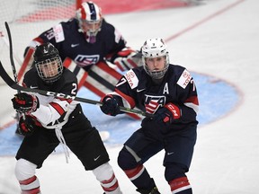 Canada's Meghan Agosta (2) vies for position with the United State's Monique Lamoureux (7) during first period Women's World Hockey Championship action in Plymouth, Mich., on Friday, March 31, 2017. THE CANADIAN PRESS/Jason Kryk