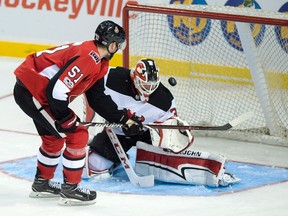 Ottawa Senators Logan Brown, left, is stopped by New Jersey Devils goaltender Cory Schneider during NHL pre-season action in Summerside, P.E.I., on Sept. 25, 2017. (THE CANADIAN PRESS/Andrew Vaughan)