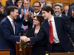 Prime Minister Justin Trudeau shakes hands with Minister of Finance Bill Morneau after he delivered the federal budget in the House of Commons on Parliament Hill in Ottawa, Wednesday March 22, 2017. (THE CANADIAN PRESS/Sean Kilpatrick)