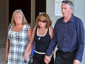 Deb Abrams, mother of Adam Kargus, centre, and her partner Ken Abrams and sister Tina McCool leave the London Courthouse on Tuesday September 25 after Anthony George who was charged with second-degree murder in the beating death of her son Adam Kargus while in the Elgin-Middlesex Detention Centre in 2013 plead guilty to the charge. (MORRIS LAMONT/THE LONDON FREE PRESS)