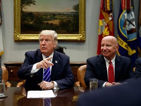 Rep. Richard Neal, D-Mass., left, and Rep. Kevin Brady, R-Texas, right, listen as President Donald Trump speaks during a meeting with members of the House Ways and Means committee in the Roosevelt Room of the White House, Tuesday, Sept. 26, 2017, in Washington. (AP Photo/Evan Vucci)