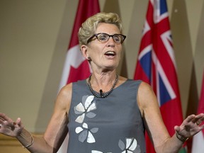 Premier Kathleen Wynne speaks at Queen's Park in Toronto. (STAN BEHAL/TORONTO SUN FILES)