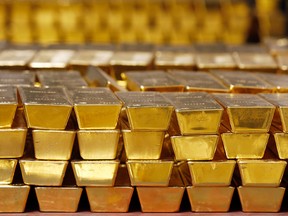 FILE - In this Tuesday, July 22, 2014, file photo, gold bars are stacked in a vault at the United States Mint, in West Point, N.Y. (AP Photo/Mike Groll, File)