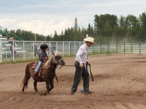 Nolan Sheilds, 3, is led around the stakes on his pony, Sugar, in the pre-peewee class at the Alberta Gymkhana Association Run at the Agriculture Society grounds on Saturday, June 29. Celia Ste Croix / Whitecourt Star