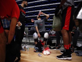 Toronto Raptors players ice their knees and quench their thirst during training camp at the University of Victoria in Victoria, B.C., on Sept. 26, 2017. (THE CANADIAN PRESS/Chad Hipolito)