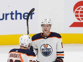 Edmonton's Kailer Yamamoto (56) celebrates a goal with Leon Draisaitl (29) during the third period of a preseason NHL game between the Edmonton Oilers and the Vancouver Canucks at Rogers Place in Edmonton, Alberta on Friday, September 22, 2017.