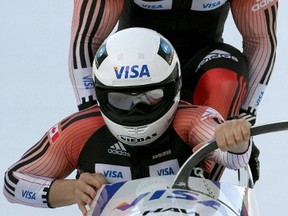 Canadian team Pierre Lueders (front) and Lascelles Brown start during the first run at the two-man Bobsleigh World Cup tournament in the Swiss mountain resort of St. Moritz Jan. 26, 2008. (Postmedia)
