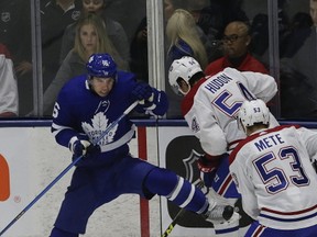 Mitchell Marner gets taken off the puck by Charles Hudon and Victor Mete in the first period, as the Toronto Maple Leafs take on the Montreal Canadiens at Ricoh Coliseum in Toronto. (Stan Behal/Toronto Sun/Postmedia Network )
