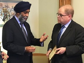 Kevin McCormick, (right) president and vice-chancellor of Huntington University and Honorary Lieutenant-Colonel of the Irish Regiment of Canada, with Defence Minister Harjit Singh Sajjan (centre) and Nickel Belt MPP Marc Serre