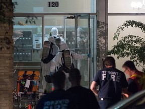 Toronto Fire Hazardous Materials Decontamination teams enter an apartment building on Broadway Ave. in Toronto on Tuesday, Sept. 26, 2017. A man was found dead in a unit that appeared to be a drug manufacturing lab. (Victor Biro/Special to the Toronto Sun)