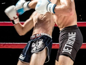 Patrick MacInnis, right, of Team Supreme punches Matt Bell at the Showdown in the Downtown: Knock Out Kidney Disease kickboxing show in London, Ont., on Saturday, Sept. 23 2017. MacInnis trains at the Bluewater Boxing Club. (MARK RUDDICK/Special to the Observer)