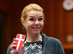 Danish Interior Minister Inger Stojberg holds her phone showing a Danish flags as she attends a Justice and Home Affairs Council at the European Council in Brussels on November 18, 2016. (EMMANUEL DUNAND/AFP/Getty Images)