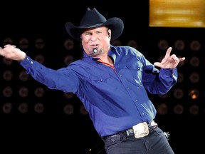 In this July 8, 2016, file photo, Garth Brooks sings "Ain't Going Down" for his opening song during a performance at Yankee Stadium in New York. Brooks announced on Sept. 27, 2017, a five-part autobiography. The first book will be released in November. (AP Photo/Julie Jacobson, File)