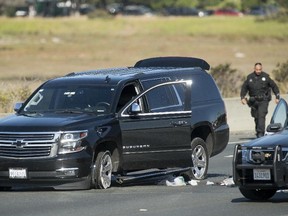Police officers investigate the scene of a standoff with a suspect driving a sports utility vehicle on westbound Interstate 80 on Wednesday, Sept. 27, 2017, in Emeryville, Calif. The incident, which ended in gunfire, shut traffic in both directions at the height of morning rush hour. (Noah Berger/AP Photo)