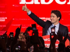 Prime Minister Justin Trudeau waves on stage in Montreal on October 20, 2015 after winning the general elections. (Nicholas Kamm/Getty Images)