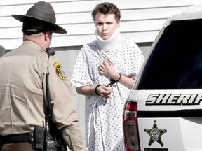 Wearing a hospital gown and neck brace, Zachary Wittke is led into a Franklin County Sheriff transport vehicle in 2013. DAVID LEAMING / KENNEBEC JOURNAL