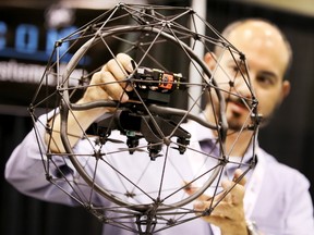 Alex Rand, CEO for Gyrfalcon, holds up a drone called Elios by Flyability on Wednesday, Sept. 27, 2017. The Big Drone Show takes place at the Metro Toronto Convention Centre Sept. 27-28. (VERONICA HENRI/TORONTO SUN)