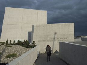 A man stops to take a photo of the Canadian National Holocaust Monument following its official opening ceremony in Ottawa, Wednesday September 27, 2017. Adrian Wyld, THE CANADIAN PRESS