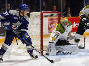 Sudbury Wolves forward Troy Lajeunesse, left, looks to make a play near North Bay Battalion goalie Mat Woroniuk during OHL action at North Bay Memorial Gardens on Wednesday, Sept. 27, 2017. Dave Dale/Postmedia Network