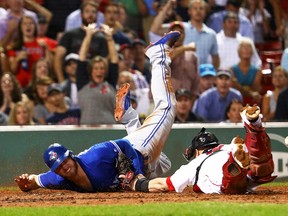 Josh Donaldson of the Toronto Blue Jays slides past Christian Vazquez of the Boston Red Sox to score a run during MLB action at Fenway Park on Sept. 27, 2017. (Maddie Meyer/Getty Images)