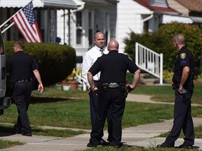 Police investigate at a home where two children were shot in Dearborn, Mich., Wednesday, Sept. 27, 2017. (Tanya Moutzalias /The Ann Arbor News via AP)
