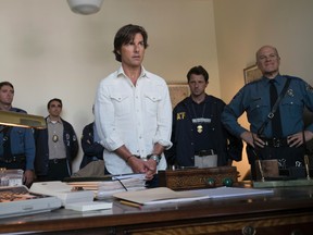 This image released by Universal Pictures shows Tom Cruise as Barry Seal in a scene from, "American Made." (David James/Universal Pictures via AP)