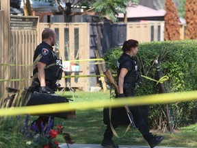 Kingston police carry rifles out of an apartment building on Runnymede Road where there was an early morning shooting in Kingston, Ont. on Monday, Sept. 25, 2017. 
Elliot Ferguson/The Whig-Standard/Postmedia Network