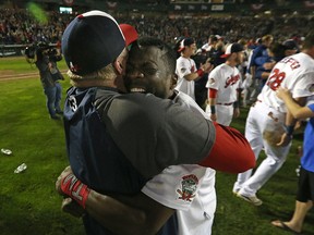 Reggie Abercrombie (right) and manager Rick Forney of the Winnipeg Goldeyes embrace after defeating the Wichita Wingnuts in Game 5 to win the American Association championship series at Shaw Park in Winnipeg on Wed., Sept. 20, 2017. Kevin King/Winnipeg Sun Files