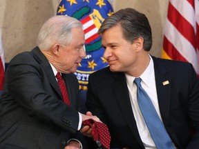 Attorney General Jeff Sessions shakes hands with Christopher Wray during a installation ceremony for Wray as the new FBI director at the FBI Building, Thursday, Sept. 28, 2017, in Washington. (AP Photo/Andrew Harnik)