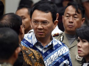 Jakarta Governor Basuki "Ahok" Tjahaja Purnama, center, talks to his lawyers after his sentencing hearing at a court  in Jakarta, Indonesia, Tuesday, May 9, 2017.
An Indonesian court on Tuesday sentenced the minority Christian governor of Jakarta to two years in prison for blaspheming the Quran, a shock decision that undermines the country’s reputation for practicing a moderate form of Islam.(Bay Ismoyo/Pool Photo via AP)