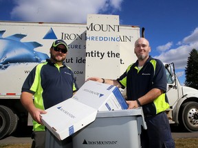 Dale Tudor, operations supervisor, left and driver Shane Nudds with a shredding truck at the Iron Mountain facility on Grant Timmins Drive in Kingston on Thursday September 28 2017. Both employees will be taking part in the Shred-a-Thon in the Cataraqui Centre parking lot on Saturday. Ian MacAlpine /The Whig-Standard/Postmedia Network