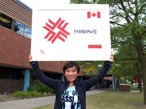 New Londoner Mery Cristyna Tarigan, from a small town in Indonesia, is so glad to be attending Fanshawe College this semester, she crafted a homemade sign to commemorate the experience. Tarigan hopes to study in London to find work and eventually raise enough money to build a school in her hometown. (CHRIS MONTANINI, Londoner)