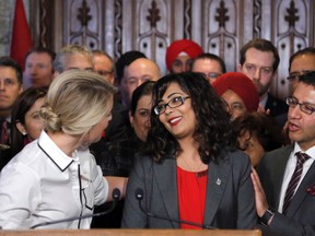 Member of Parliament Iqra Khalid is congratulated by colleagues as she makes an announcement about an anti-Islamophobia motion on Parliament Hill in Ottawa on Wednesday, February 15, 2017. (THE CANADIAN PRESS/Patrick Doyle)