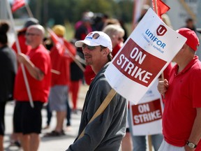 Pickets walk the line outside the strikebound Cami car factory in Ingersoll Thursday, as the focus in the strike by 2,800 workers shifted to getting top executives in General Motors in Detroit involved in the stalemate.  (BRUCE CHESSELL, Woodstock Sentinel-Review)