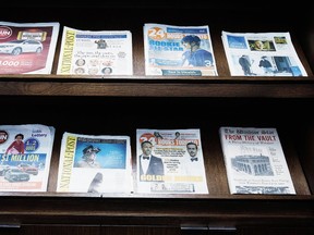 Postmedia newspapers are on display during the company's annual general meeting in Toronto on Jan. 12, 2017. (Nathan Denette/The Canadian Press)