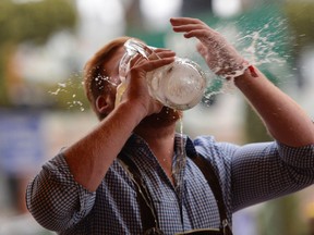 A reveller spills beer as he tries to empty his stein in one sitting at the Hofbraeu tent on the opening day of the 2015 Oktoberfest on September 19, 2015 in Munich, Germany. (Photo by Philipp Guelland/Getty Images)