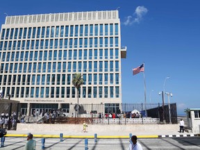In this Aug. 14, 2015, file photo, a U.S. flag flies at the U.S. embassy in Havana, Cuba. Senior U.S. officials say the United States is pulling roughly 60% of its staff out of Cuba and warning American travelers not to visit due to “specific attacks” that have harmed U.S. diplomats. (AP Photo/Desmond Boylan, File)