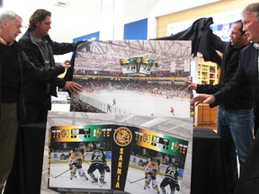 Sarnia Mayor Mike Bradley, left, Sting co-owners Derian Hatcher and David Legwand, and team president Bill Abercrombie unveil renderings Friday for a new score clock and digital banner ring at the Progressive Auto Sales Arena. The hockey team is footing the cost, billed at more than $500,000. (Tyler Kula/Sarnia Observer)