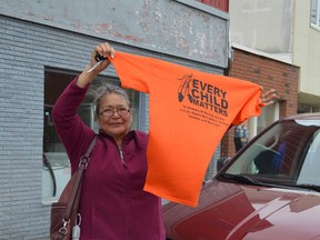 Agathe Nakogee keeps her orange shirt on hand - just in case. She didn't realize that Friday was Timmins' walk for Orange Shirt Day, but pulled out her shirt to cheer on walkers when she saw them walk by. Nakogee, who is from Fort Albany, went to St. Anne's residential school in 1962 at the age of three.
