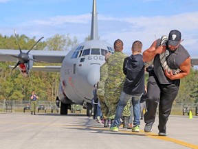 TIM MEEKS/THE INTELLIGENCER
Members of 704 Air Cadets Squadron and some friends pull a CC130 Hercules during the annual Community Fair held Friday at 8 Wing Trenton.