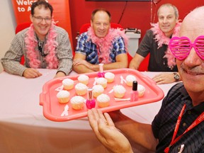 Luke Hendry/The Intelligencer
Lou Lanthier, the Belleville and Ottawa site leader for Avaya Canada Corp., holds a tray of cupcakes, nail polish and pink ribbons at the company's Sidney Street office in Belleville Friday. Joining him were staff Chris McArthur, left, Scott LaTour and Bob Dafoe. Staff of the telecommunications company are preparing to raise funds for the Canadian Cancer Society's Breast Cancer Awareness Month through cupcake sales, pink manicures and more.