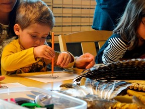 Brodie Harvey was one of numerous children treated to a presentation by Oneida artist Todd Jamieson Friday morning, where they were given drawings of animals to colour in. The event, held as part of Culture Days, was the brainchild of a local group called Journey Together and was built in part to foster appreciation for First Nations cultures. (Louis Pin/Times-Journal)