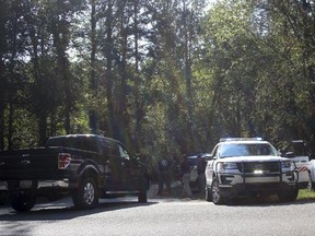 Polk County, Ga. law enforcement officials look for a suspect involved in a shooting that killed a police officer and injured another on Friday, Sept. 29, 2017, in Cedartown, Ga. (Kevin Myrick/Polk County Standard Journal via AP)