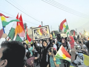 Syrian Kurds pose with a picture of Iraqi Kurdish leader Masoud Barzani, while celebrating in the northeastern Syrian city of Qamishli on Monday in support of the independence referendum in Iraq?s Kurdistan Autonomous Region. The Iraqi Kurds?s vote is angering not only Iraq, but also neighbouring countries Turkey, Iran and Syria that have sizable Kurdish populations. (DELIL SOULEIMAN/AFP/Getty Images)