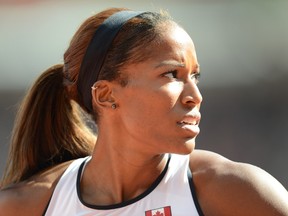 Canadian Phylicia George of Toronto competes in the women's 100 meter hurdles at Olympic Stadium during the London Olympics on Aug. 6, 2012. (AL CHAREST/CALGARY SUN)