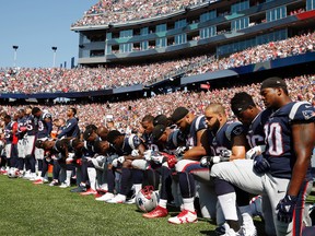In this Sept. 24, 2017 file photo, several New England Patriots players kneel during the national anthem before an NFL football game against the Houston Texans in Foxborough, Mass. (AP Photo/Michael Dwyer, File)