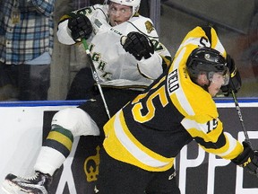 London Knights? Josh Nelson takes a shot from Sam Field of the Kingston Frontenacs during the first period of their OHL game at Budweiser Gardens on Friday night. The Frontenacs pounded the Knights on the scoresheet as well, winning 5-0. (DEREK RUTTAN, The London Free Press)